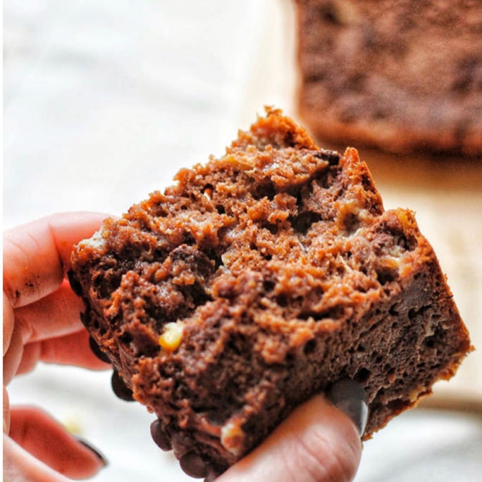 Closeup of a person holding a brownie