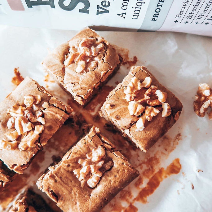 Free Soul protein powder in front of a walnut cake