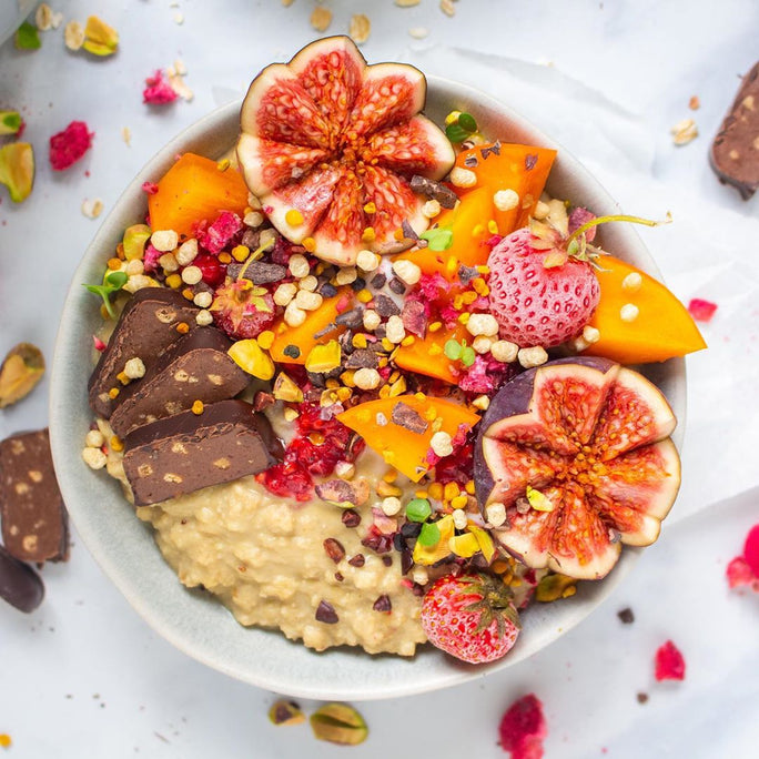 A bowl filled with oats, cut fig and chopped up protein fudge
