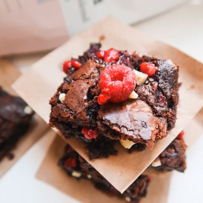 Chocolate brownies with white chocolate chips and fresh raspberry toppings