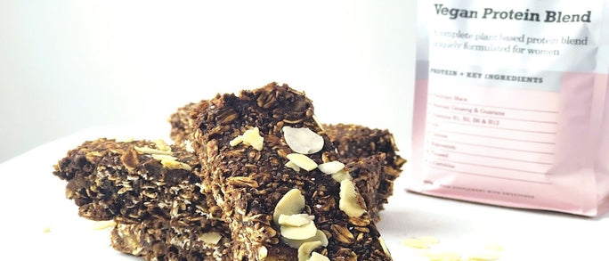 Three flapjack slices in front of vegan protein blend packaging