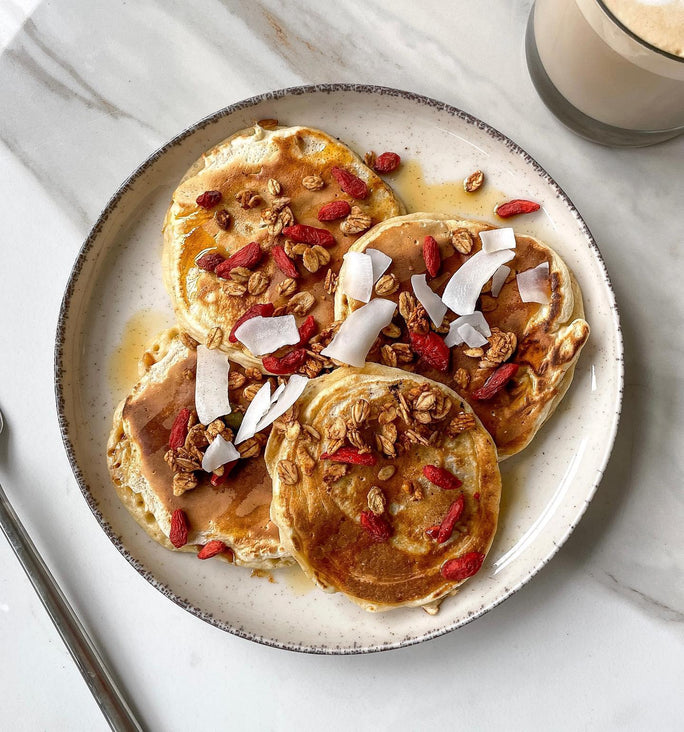 Golden pancakes topped with oats and coconut