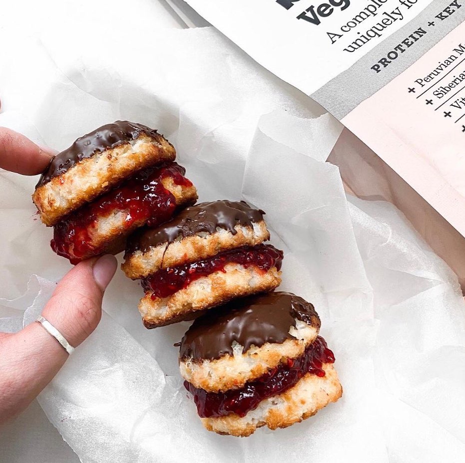 Small macaroon bites topped with chocolate and jam
