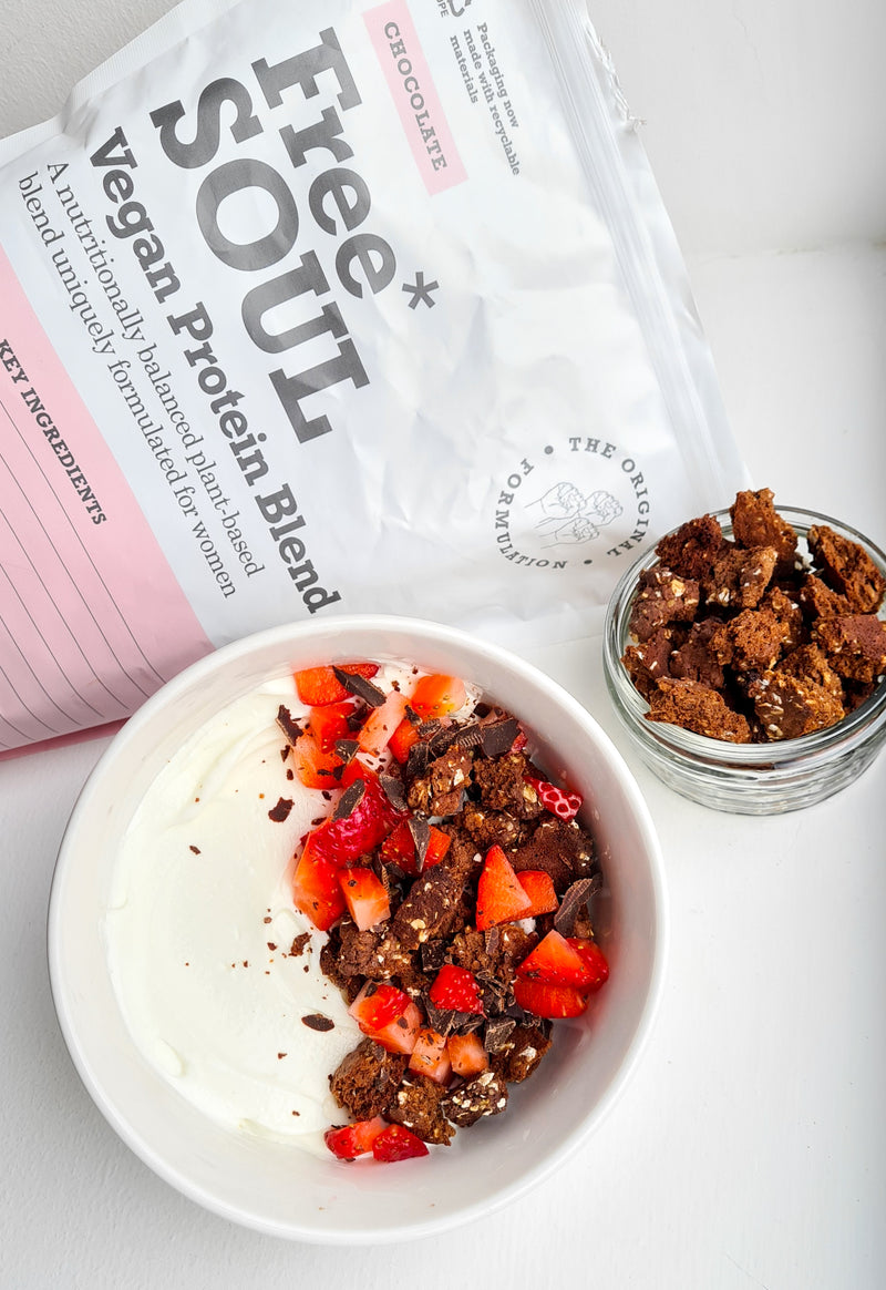 A white bowl next to a bag of Free Soul protein