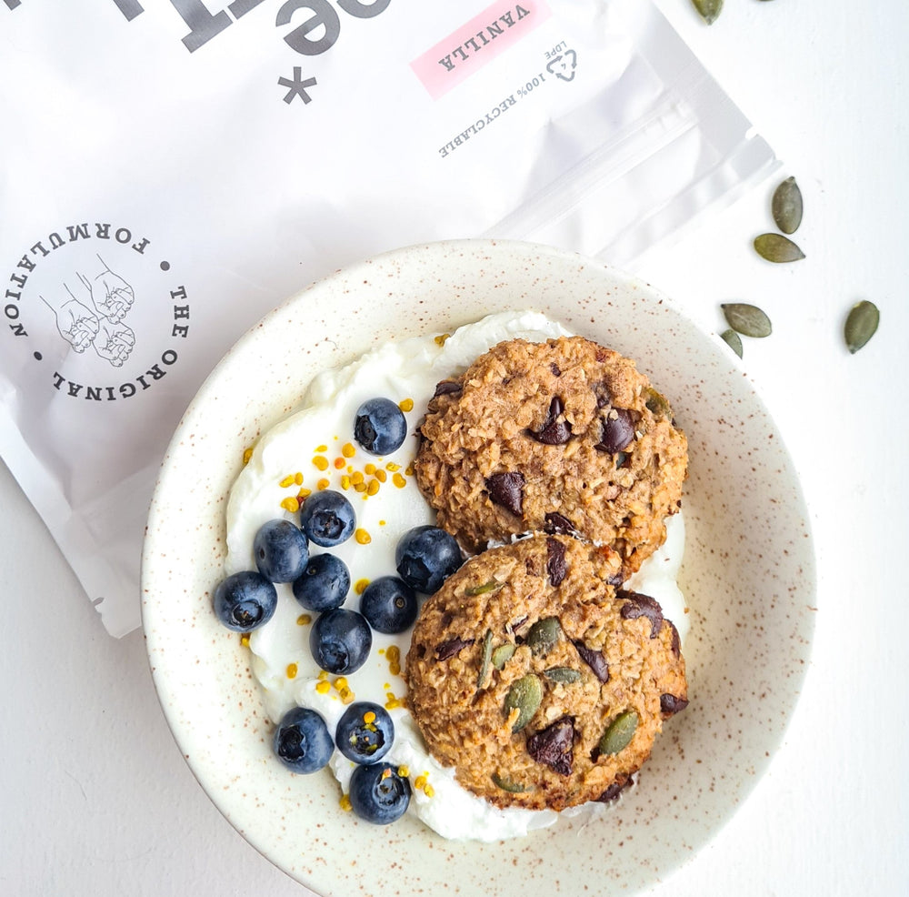 A bowl of yoghurt, 2 protein breakfast cookies and fresh blueberries