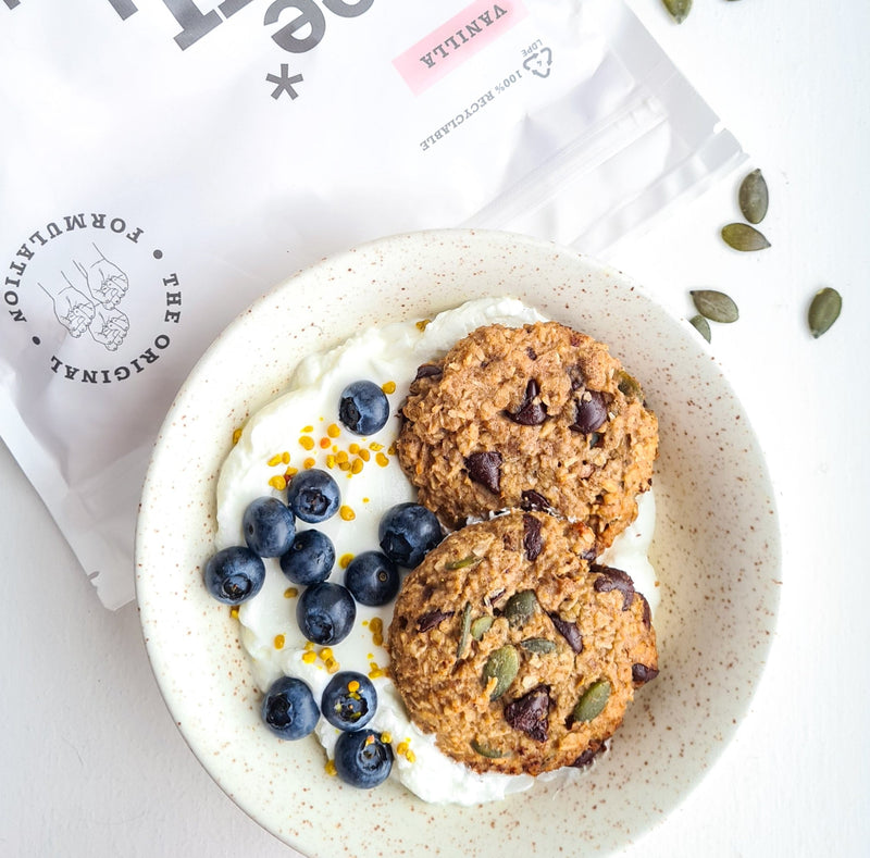 A bowl of yoghurt, 2 protein breakfast cookies and fresh blueberries