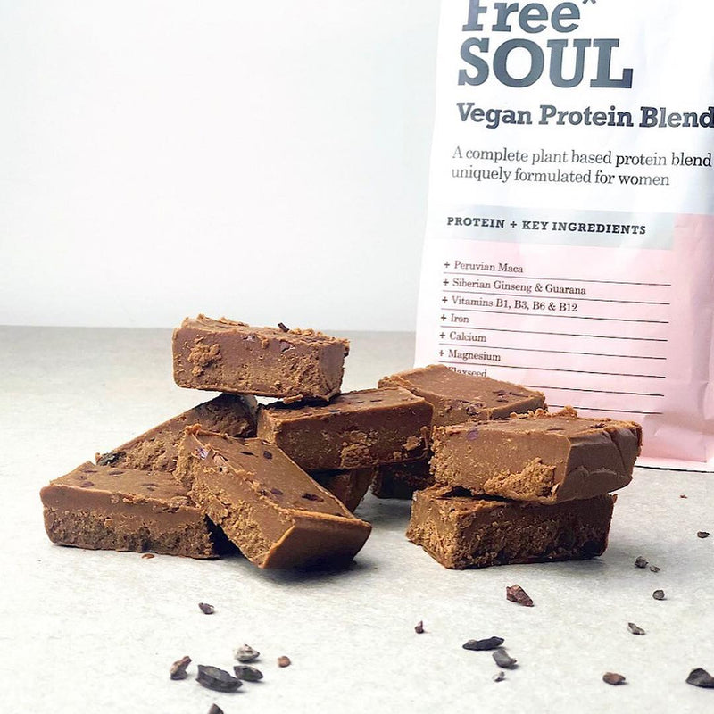 Free Soul protein powder in front of a walnut cake