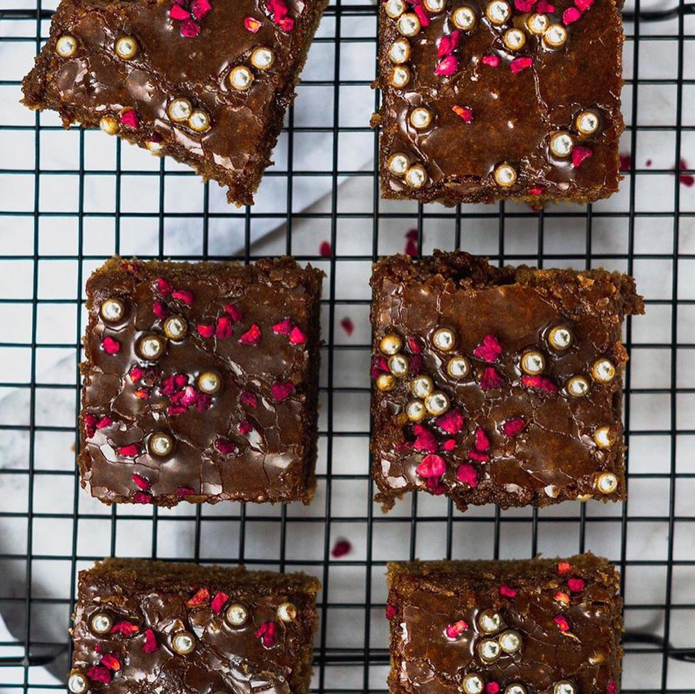 Chocolate brownies with crispy toppings on a black cooling rack