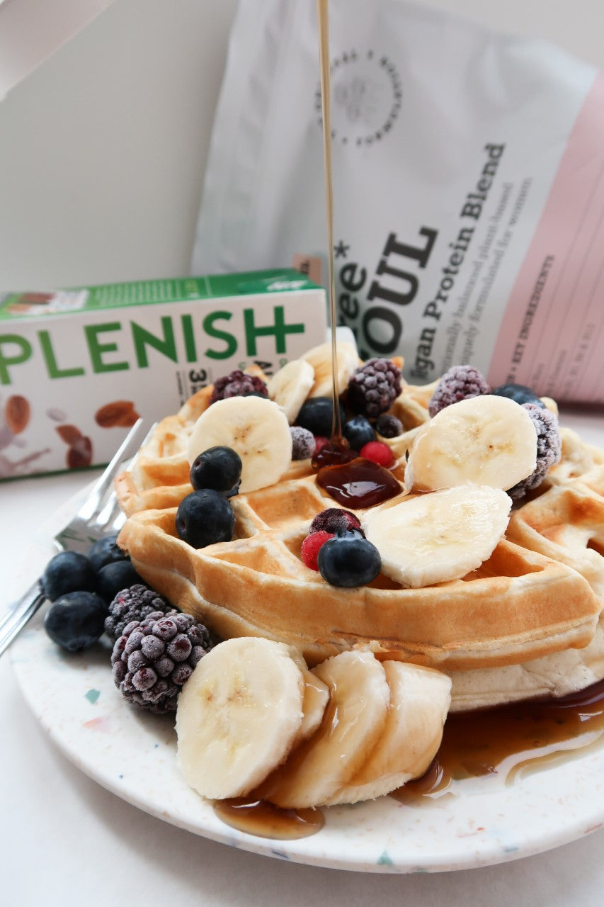 Golden waffles in front of Free Soul protein powder and Plenish plant-based milk