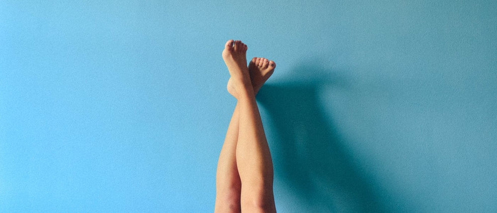 Legs crossed over a bright blue background