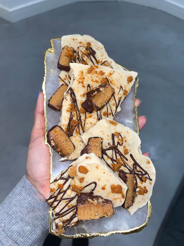 A long plate of filded craped with cut protein bars and drizzled chocolate on top