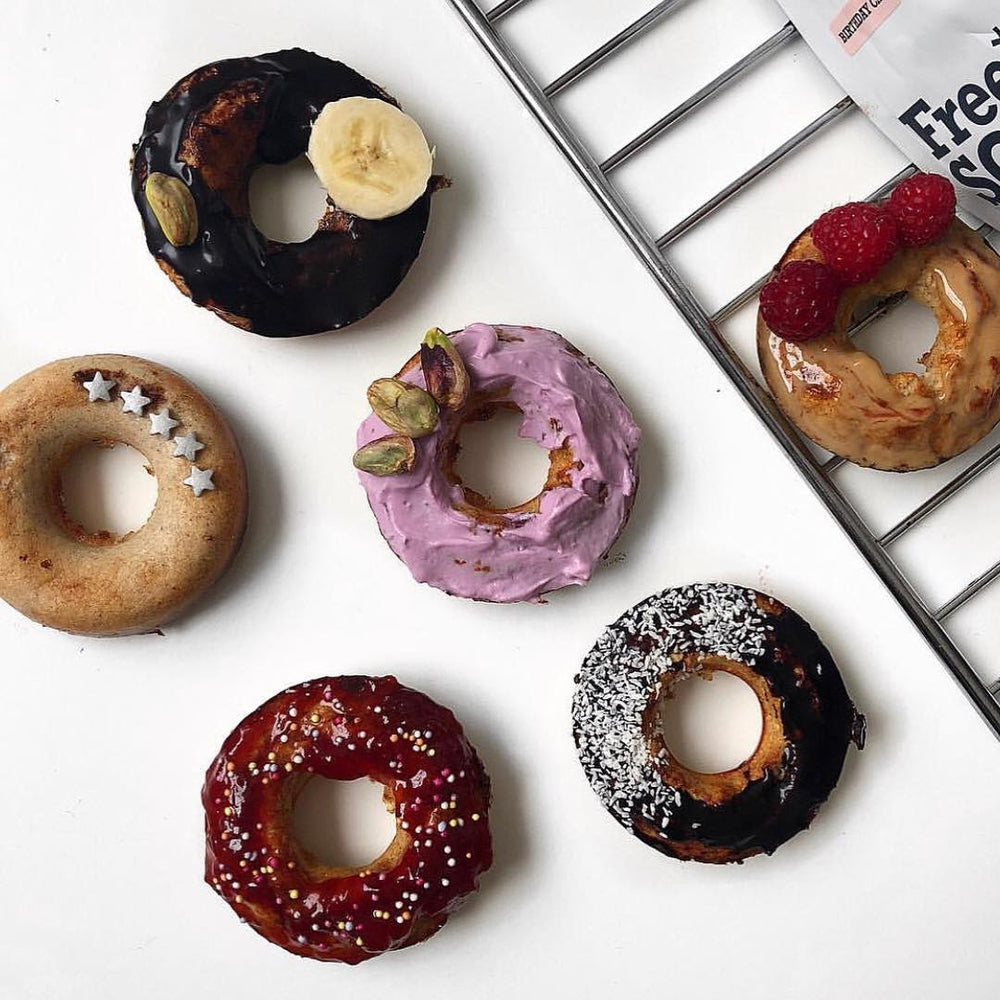 Miniture donughts next to a silver baking tray and a bag of Free Soul protein