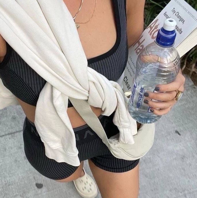 Girl walking with her water bottle and book