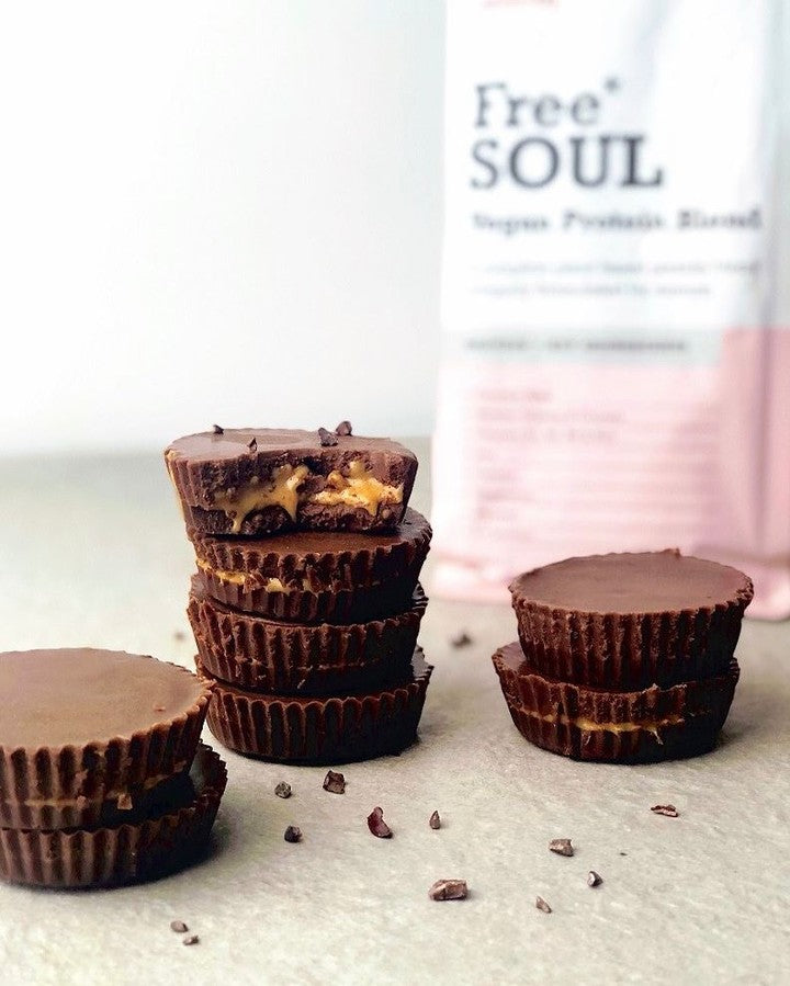 Stacked chocolate & caramel muffins with a Free Soul packaging in the background 