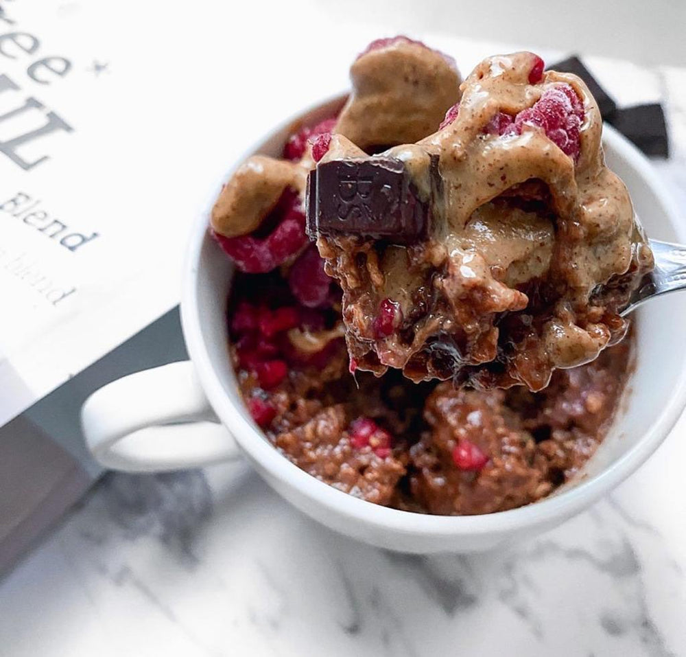 A microwave chocolate mugcake with dark chocolate, peanut butter and raspberries