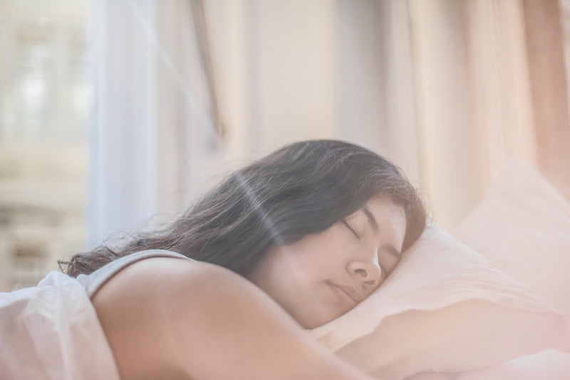 A woman sleeping on a pillow