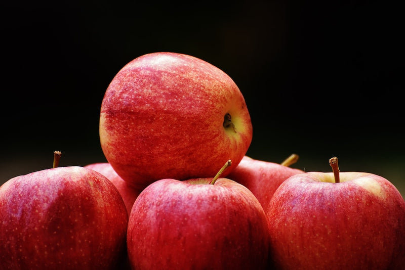 Crisp red apples on a pitchblack backdrop
