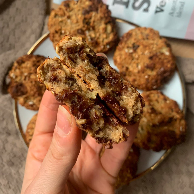 Close up of a hand holding freshly baked cookies